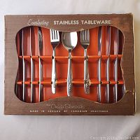 Vintage Oneida Silversmiths stainless steel flatware set in original box showing knives, forks and spoons.