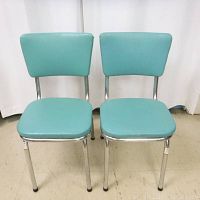 Front view of both chairs showing blue vinyl seats and backs on chrome frames