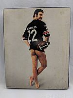 Front of puzzle box featuring Burt Reynolds with football jersey number 22 and posing nude.