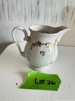 Front view of porcelain jug showing gold decoration and shape