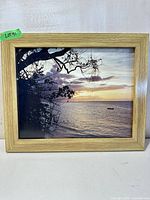Front view of framed beach sunset photograph