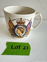 Front view showing portrait, crest, text and handle
