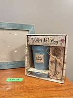 Boxed Flower Pot Mug set beside blue frame close-up