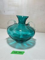 Front view of teal glass vase showing color and handle detail