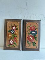 Front view of both copper floral plaques mounted on wood
