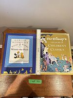 Front covers of both hardcover books displayed side by side with ruler for scale