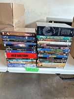 Two stacks of DVD movies on table