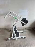 Side view of Lumex stand assist lift showing frame, knee pads, casters