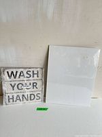 Metal sign and canvas side by side