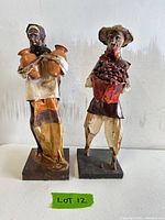 Front view of both Mexican folk art figures on bases