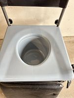 Top view showing removable plastic pan in seat opening