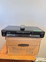 Front view of Panasonic DVD-RV41 player with remote on top