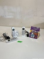 Overall lot with three Panasonic handsets, two cradles, adapters, cord and boxed Omron monitor