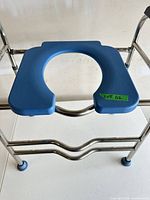 Overall view showing blue seat, chrome frame, adjustable legs