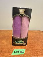 Front of unopened box displaying two rolled handkerchiefs