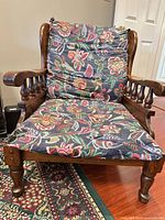 Front view of solid wood armchair with cushions