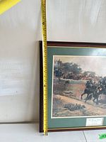 Full view showing framed print with measuring tape indicating height