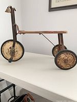 Side profile showing full tricycle structure and materials