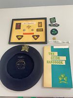 Overview of beret, handbook, framed badge board and loose patches
