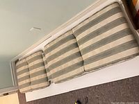 Full view of three-section lounge cushion on white board