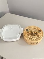 CorningWare casserole with lid beside boxed brie baker