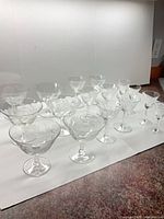 Sixteen clear crystal stemware pieces grouped together