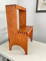 Left rear angle showing honey finish, dovetail joints and arched leg cutouts