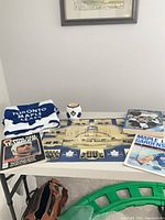 Overview of blanket, drink holder, poster, yearbook, program on table