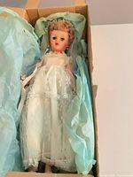 Doll in original box wrapped in blue tissue