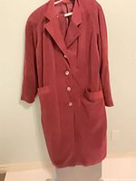 Front view of burgundy ultrasuede coat showing buttons, lapel, pockets