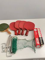Full lot with paddles, net, clamps, posts, boxed balls visible