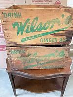 Front view of both crates showing green Wilson's Ginger Ale branding