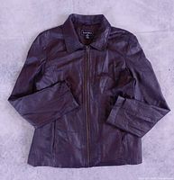 Front view of dark brown leather jacket zipped