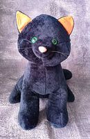 Full frontal view of black cat plush