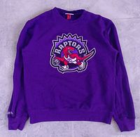 Full front view of purple Raptors crewneck