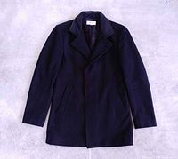 Full front view of black Reiss pea coat laid flat