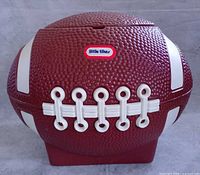 Front view of Little Tikes football toy chest showing laces, logo and overall form