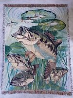 Full view of quilt showing fish artwork, fringe and overall size