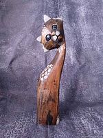 Full view front of wooden cat sculpture standing upright
