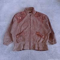 Front view of light brown leather jacket laid flat