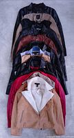 Stack of jackets showing variety of colors and materials