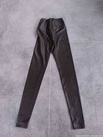 Full view of leggings laid flat showing color, cut and length