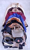 Overall view of jackets, bags, shoes and accessories stacked