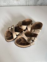 Top view of beige Birkenstock sandals showing straps, buckles and footbed wear