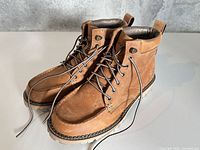 Three-quarter view of both boots showing uppers, laces and soles