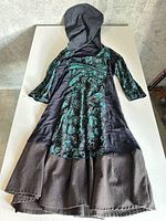 Full view of dress laid flat showing overall design and condition