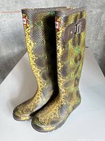 Front angled view of both boots showing snake pattern and Hunter logo