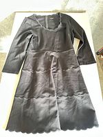 Front view of full dress showing scalloped neckline, tiered scallop seams and hem