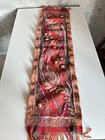 Full view of long knit scarf laid flat