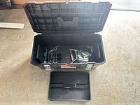 Toolbox open showing interior, wrenches, plane, small tools